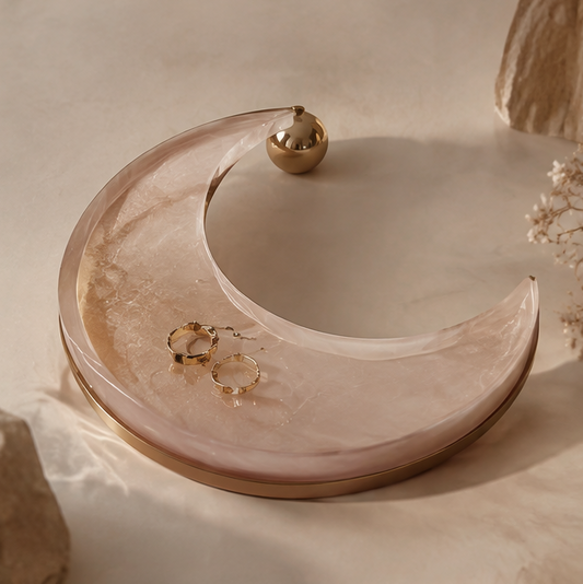 Pink marble resin crescent moon tray with gold hoop earrings — clean background