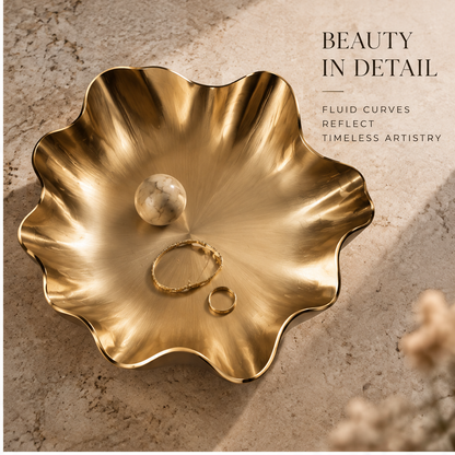 Top-down view of gold wave tray with marble ball and rings — Beauty in Detail